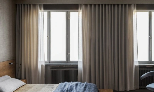 blackout curtain dubai drapes that are currently partially drawn, providing light control.