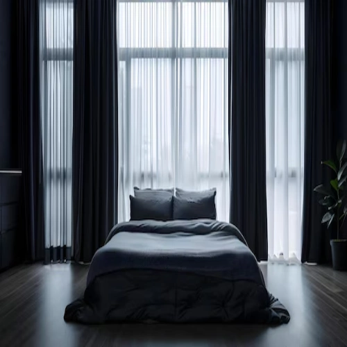 A modern industrial bedroom featuring blackout curtains in a dark charcoal fabric, paired with floor-to-ceiling sheer panels.