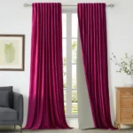 Rod Pocket living room blackout curtains in a bold pink hue installed on large windows overlooking a lush green garden.