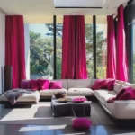 Rod Pocket living room blackout curtains in a bold pink hue installed on large windows overlooking a lush green garden.