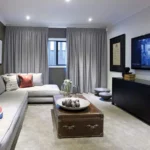 floor-length living room blackout curtains in a textured grey fabric that frame a central window.