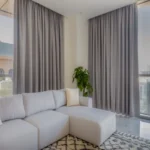 linen-look living room blackout curtains in a soft charcoal hue, framing large windows and providing privacy and style.