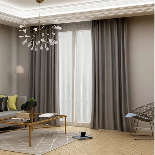living room blackout curtains in a charcoal grey fabric, paired with sheer white panels