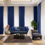 soft touch living room blackout curtains in a deep royal blue, layered over white sheer drapes.