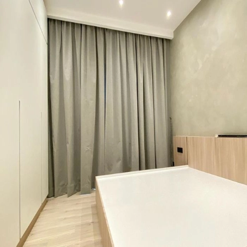 Modern floor-to-ceiling blackout curtains in Dubai installed in a contemporary bedroom