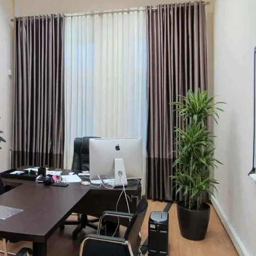 Professional executive workspace featuring home office blackout curtains in a sleek, dual-toned chocolate brown and bronze fabric.