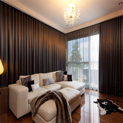 high-end living room featuring Motorized blackout curtains in a deep chocolate brown or charcoal tone.