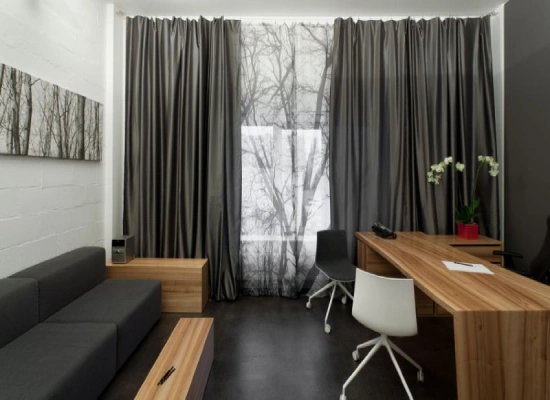 A modern workspace featuring home office blackout curtains in a sophisticated charcoal grey