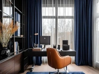 A modern executive workspace featuring home office blackout curtains in deep navy blue, layered over sheer white drapes.
