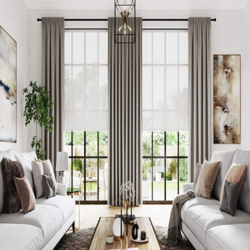 Modern living room with large windows dressed in livingroom blackout curtains.