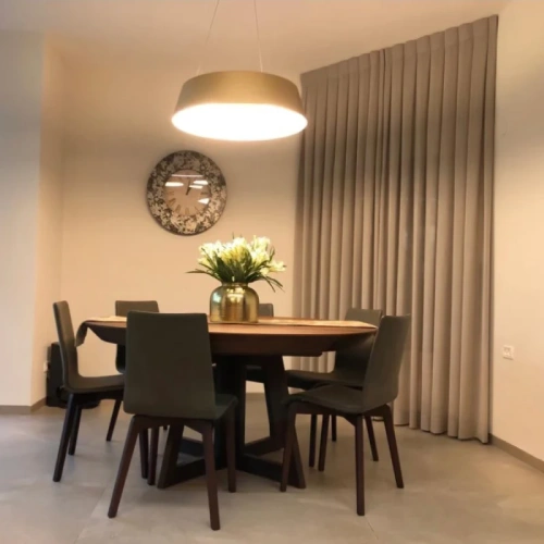 floor-to-ceiling beige dining area blackout curtains that create a private and elegant atmosphere.